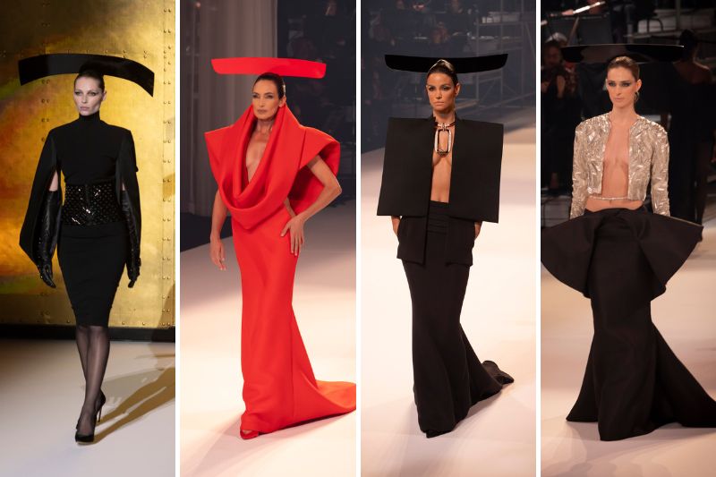 Quattro modelle sfilano indossando abiti haute couture di Stéphane Rolland per la collezione Autunno/Inverno 2025, tutte con copricapi scultorei neri o rossi. I look includono un abito nero con mantello, un abito lungo rosso fluido, un completo nero con top strutturato e un top argento scintillante con gonna ampia nera.
