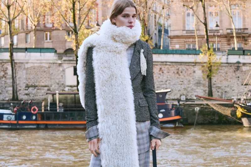 Look Dior Fall 2026 con cappotto sartoriale e maxi sciarpa in pelliccia chiara, silhouette elegante ispirata al nuovo corso di Jonathan Anderson