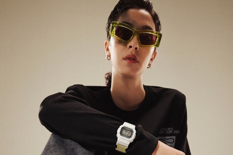 Modella con occhiali verdi e orologio G-Shock bianco della capsule G-Shock X Propaganda