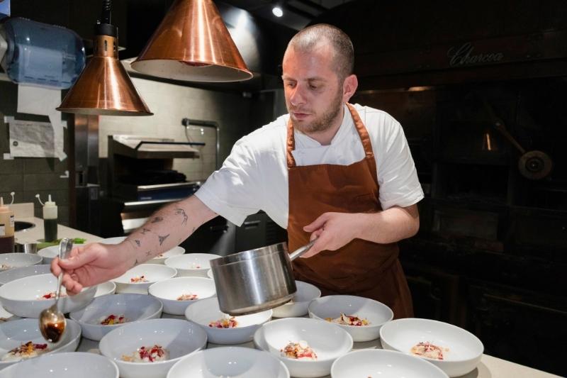 Leonardo D’Ingeo nella cucina di Alto Rooftop mentre impiatta i piatti del suo menu contemporaneo